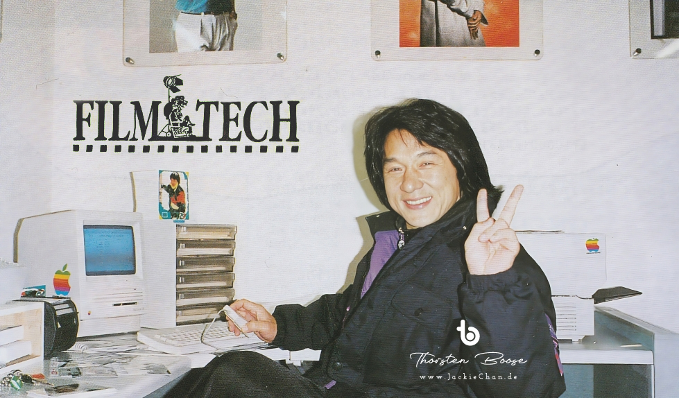 Jackie Chan promotes the new Filmtech jacket in his office, 1990